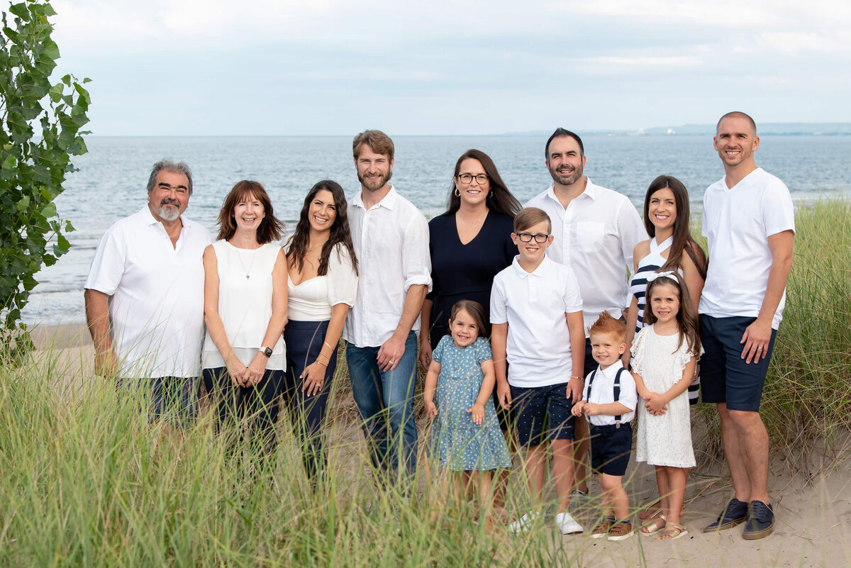 Extended Family photos with 12 people at their Burlington Beach family photographer session wearing white and blue