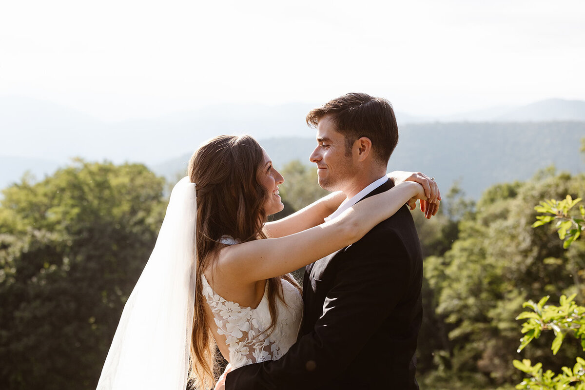 Newlyweds with their arms around each other smiling