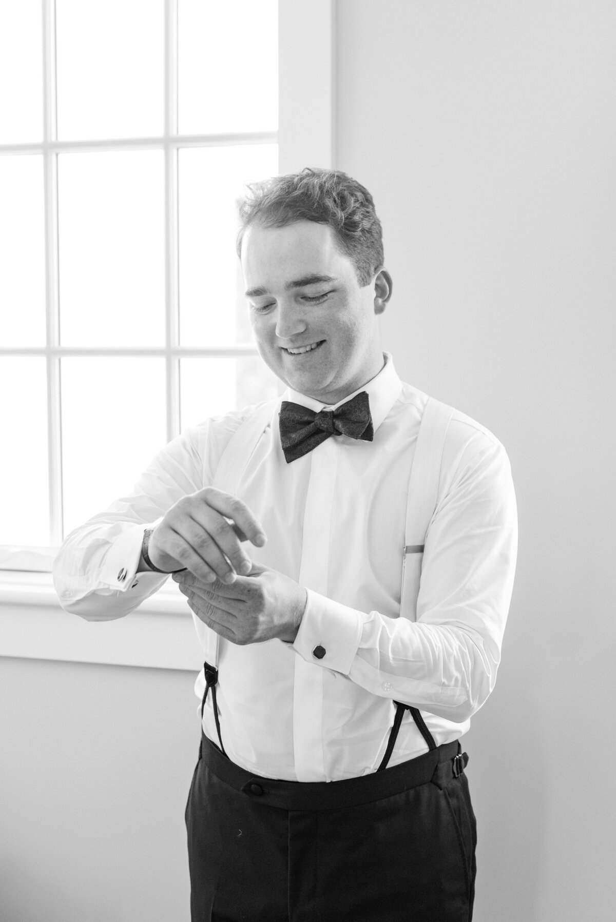 Groom getting ready before his Veuve-inspired wedding at Palmetto Bluff in Charleston, SC. Photographed by Charleston Wedding Photographer Dana Cubbage.