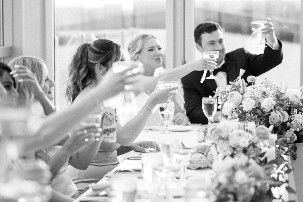 candid photo of bridal party and bride and groom toasting during their reception at Revery in Columbus, Ohio
