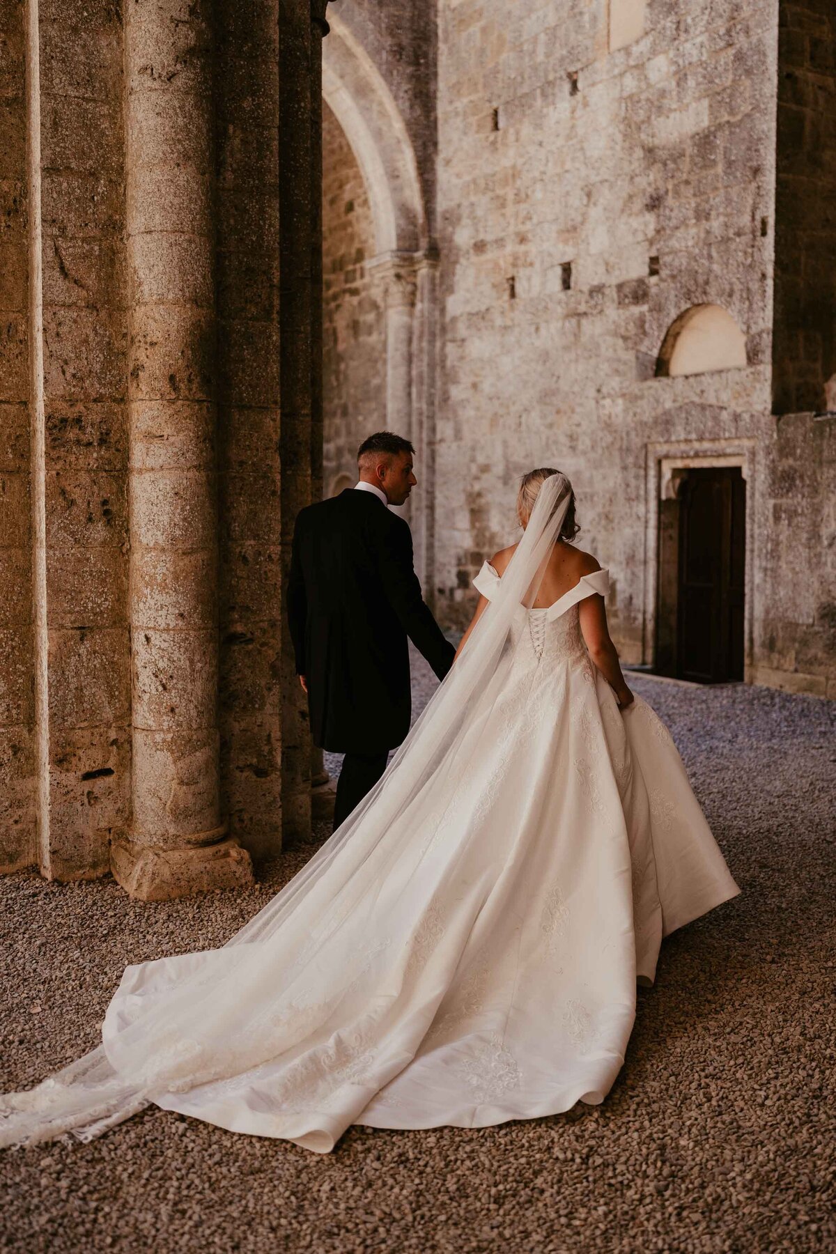 Bride & groom walking at San Galgano Abbey-1