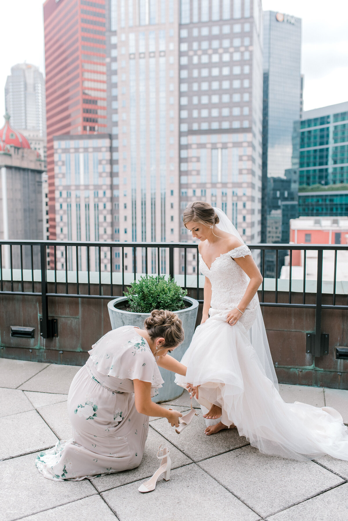 Bride getting ready on the balcony overlooking Pittsburgh skyline
