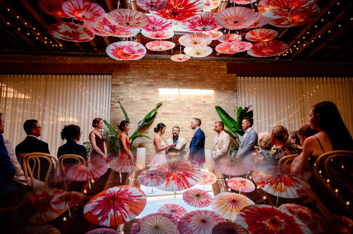 Chinese umbrellas on ceiling during wedding ceremony
