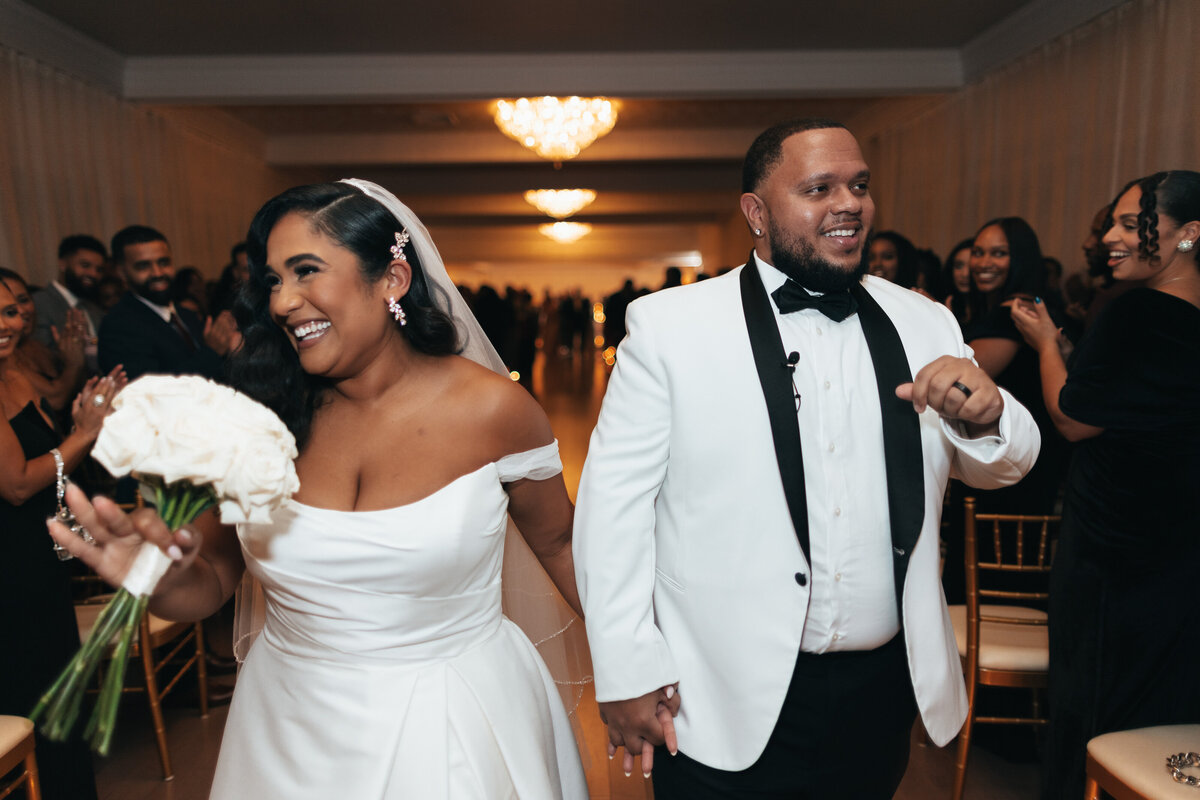 Bride and groom walking down the wedding aisle