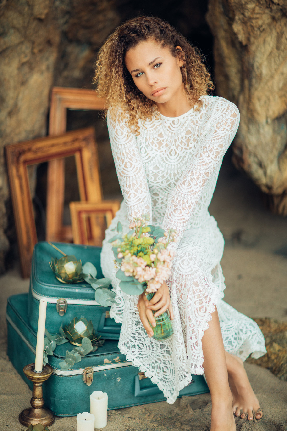 Portrait Photo Of Young Black Woman Seated On a Suit Case While Holding Flowers Los Angeles