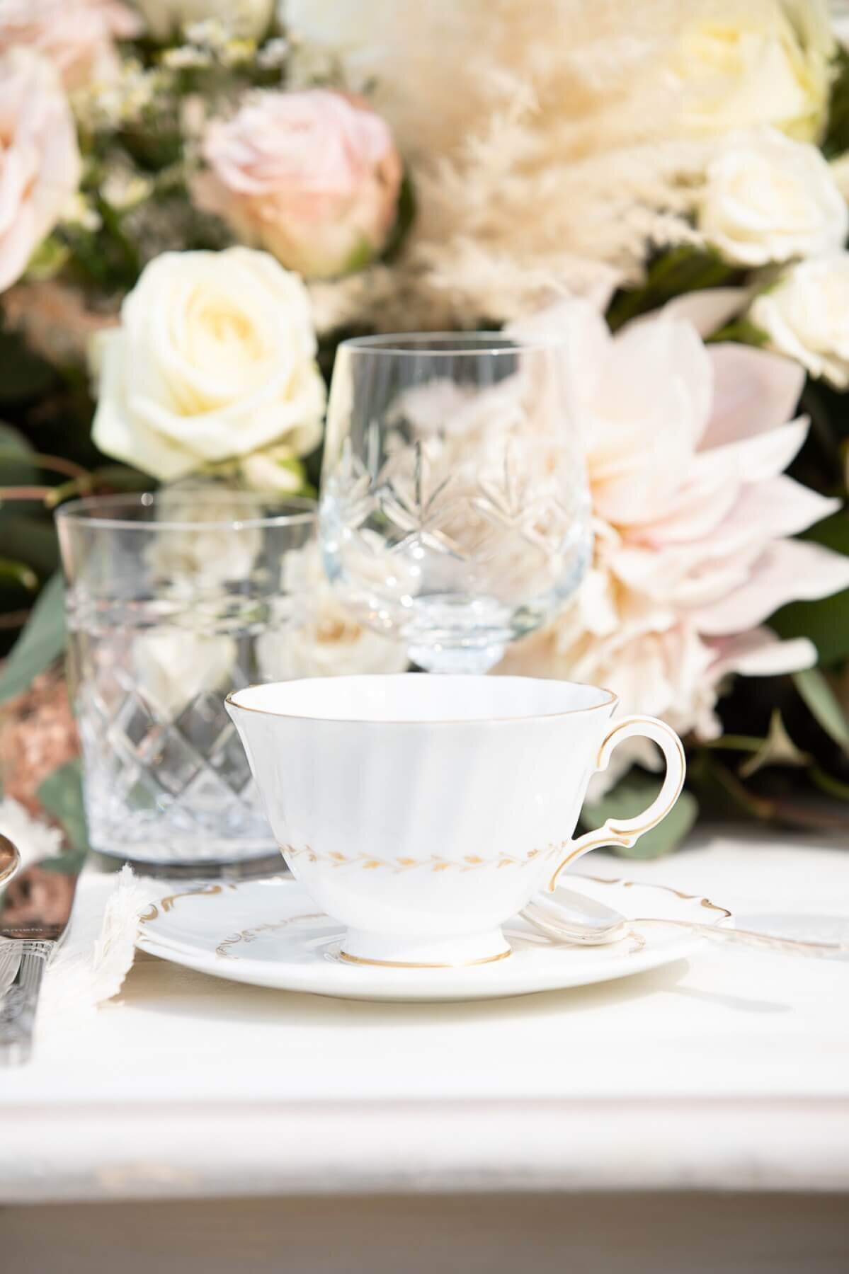 Classic white china tea cup with gold detailing