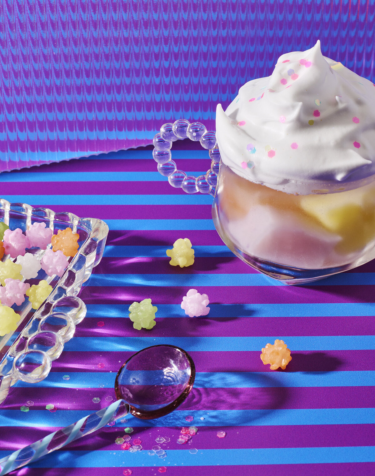 candy and whipped cream drink on striped backdrop