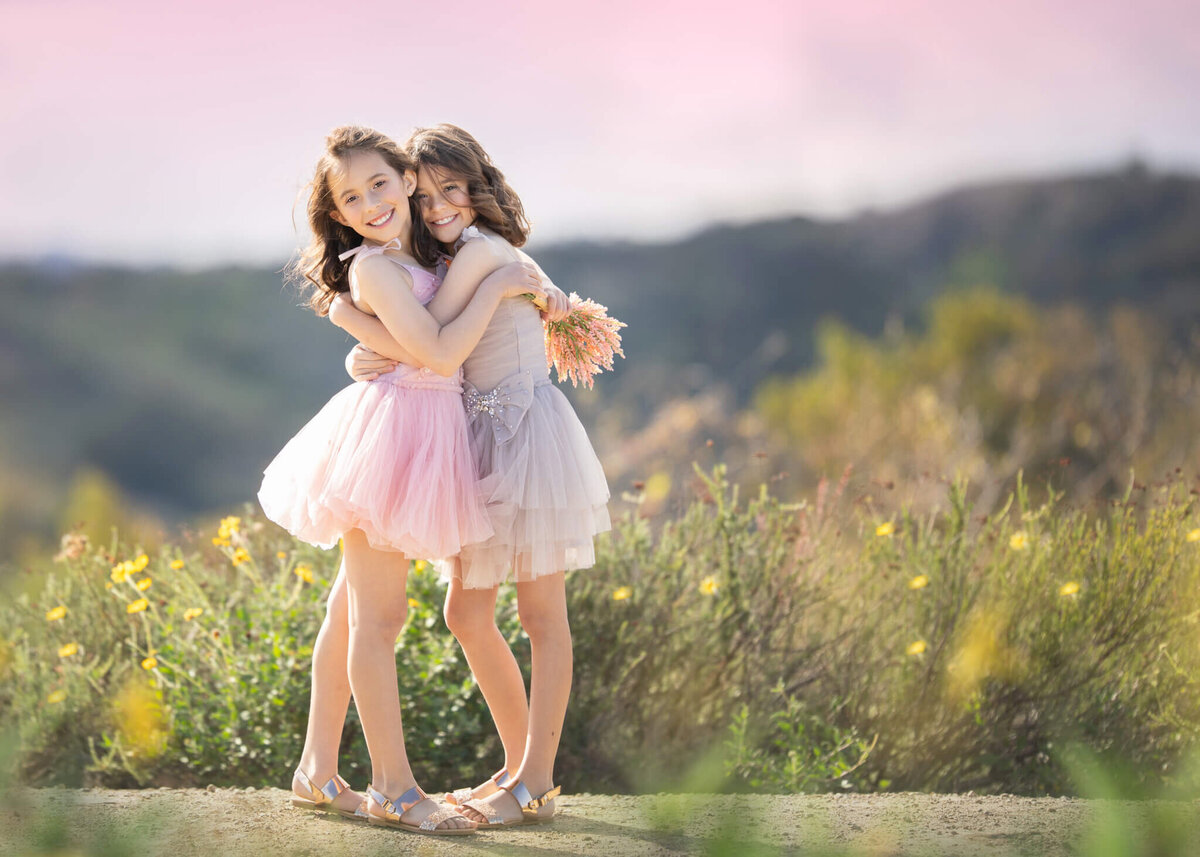 sisters hugging at sunset in a Los Angeles park - Los Angeles Children's Photographer