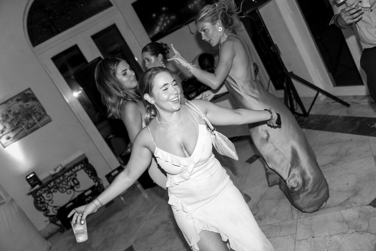 Bride dancing with girls at wedding reception, taken by wedding film photography
