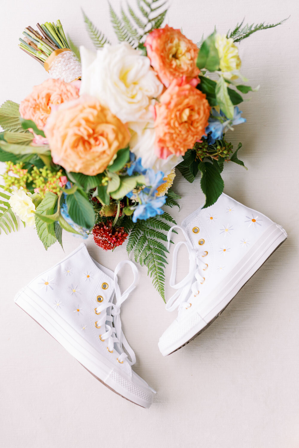 Flat lay of brides shoes and bouquet