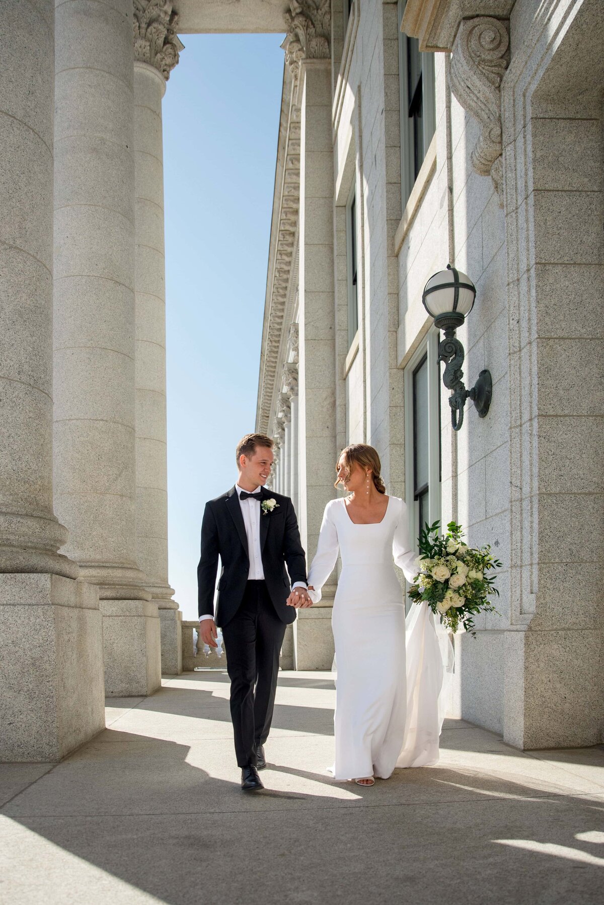 Sunset wedding photos with couple in wedding attire walking