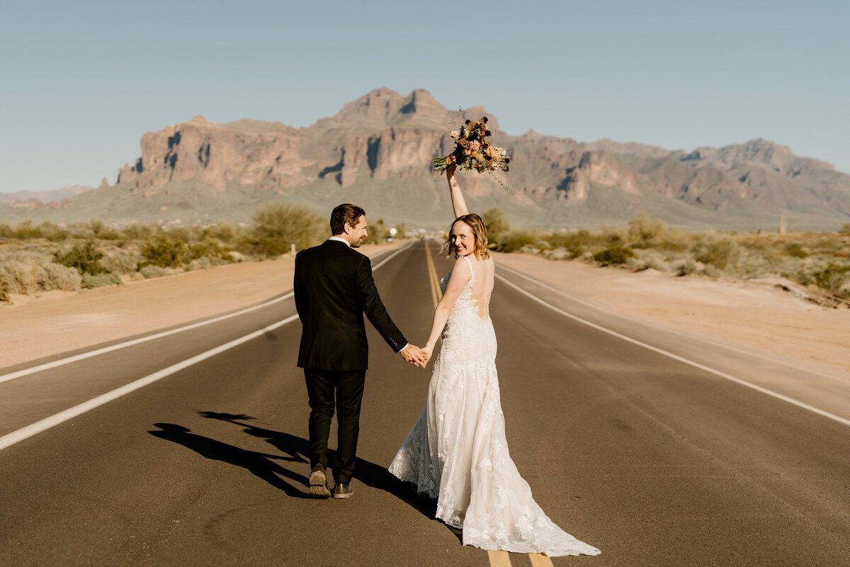 newlyweds walk down arizona road