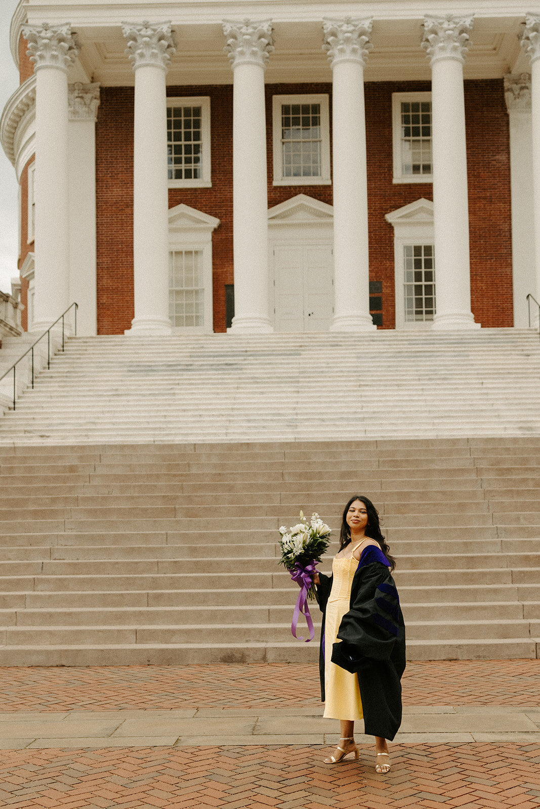 Graduate posing in front of UVA rotunda during graduation session with Three Bridge Photography