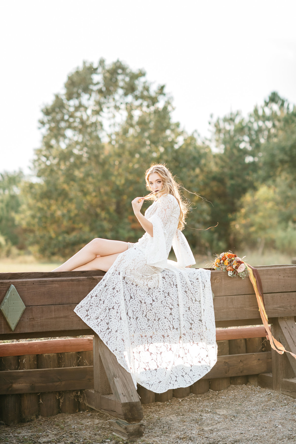 Stable View Wedding Photographer - Bride sitting on horse jump