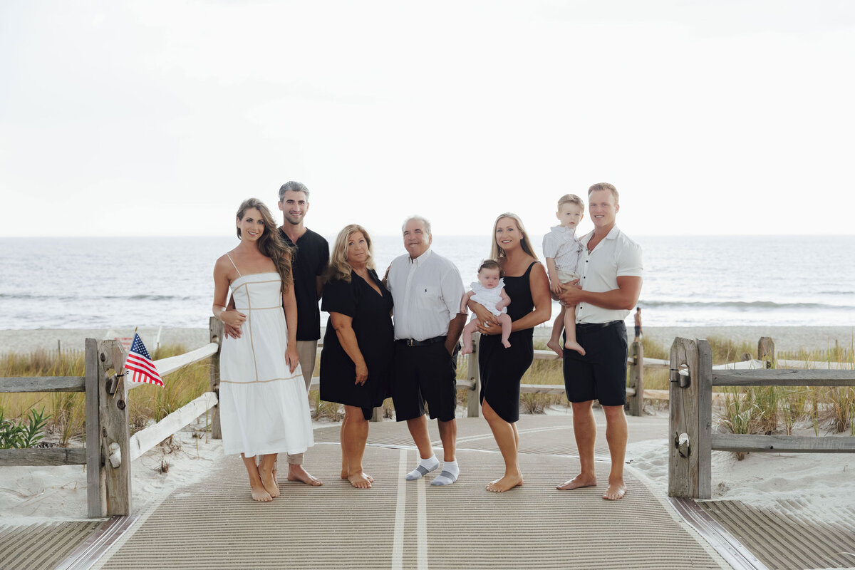 Family Photographer | Family walking along the beach during a summer sunset session | Lavallette, New Jersey