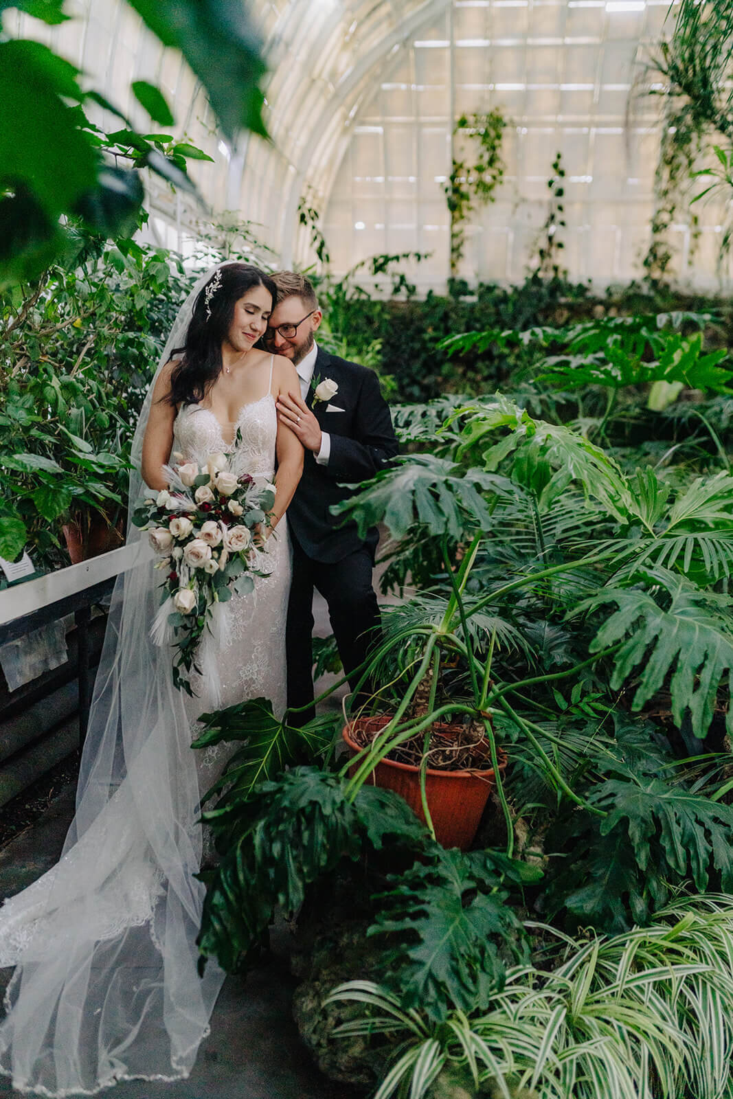 Bride and groom amongst green foliage at Finger Lakes wedding, NY