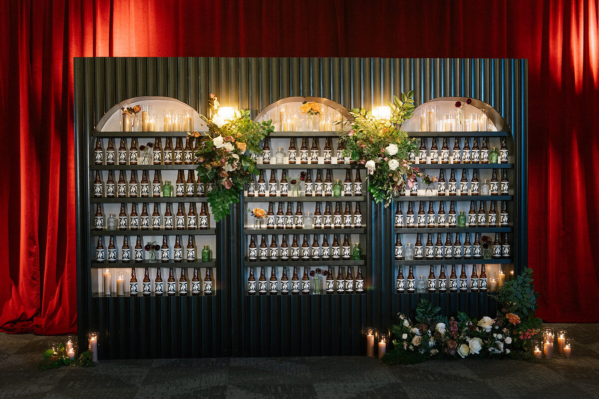 Beer bottle escort card wall with  beer label table numbers