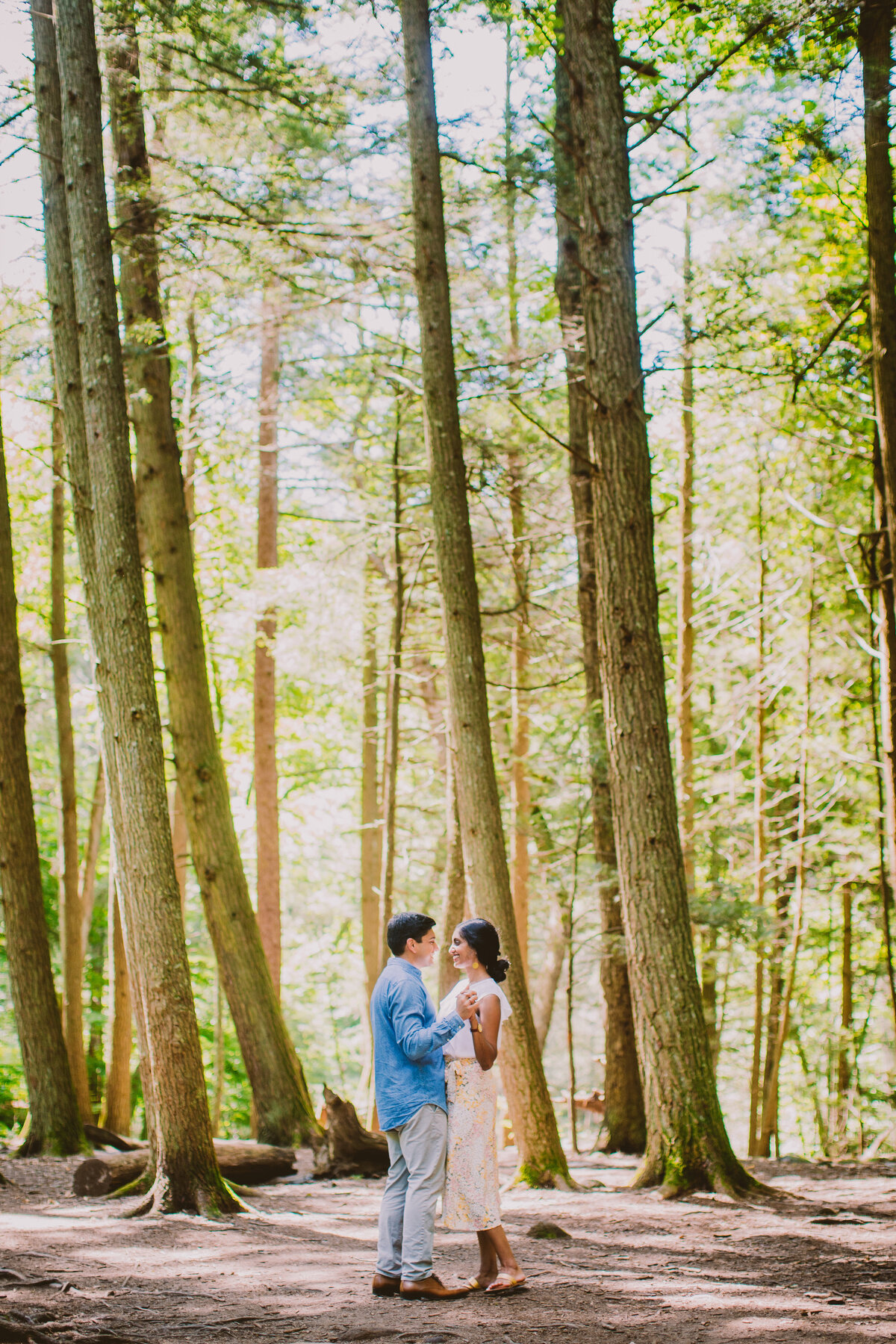A couple doing a slow dance in the forest at devils hopyard state park in connecticut
