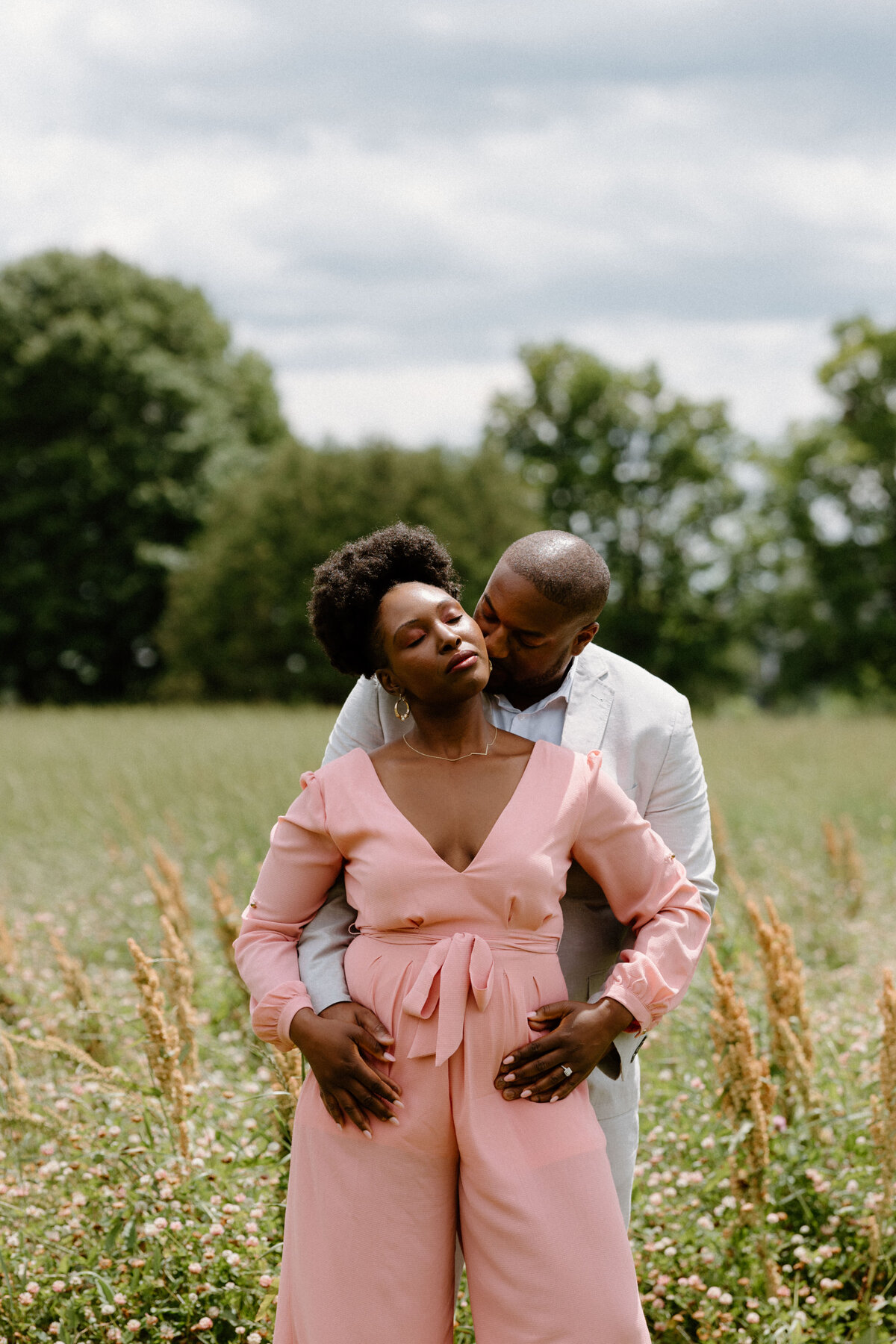 A couple hugs at the fields afther their engagement proposal