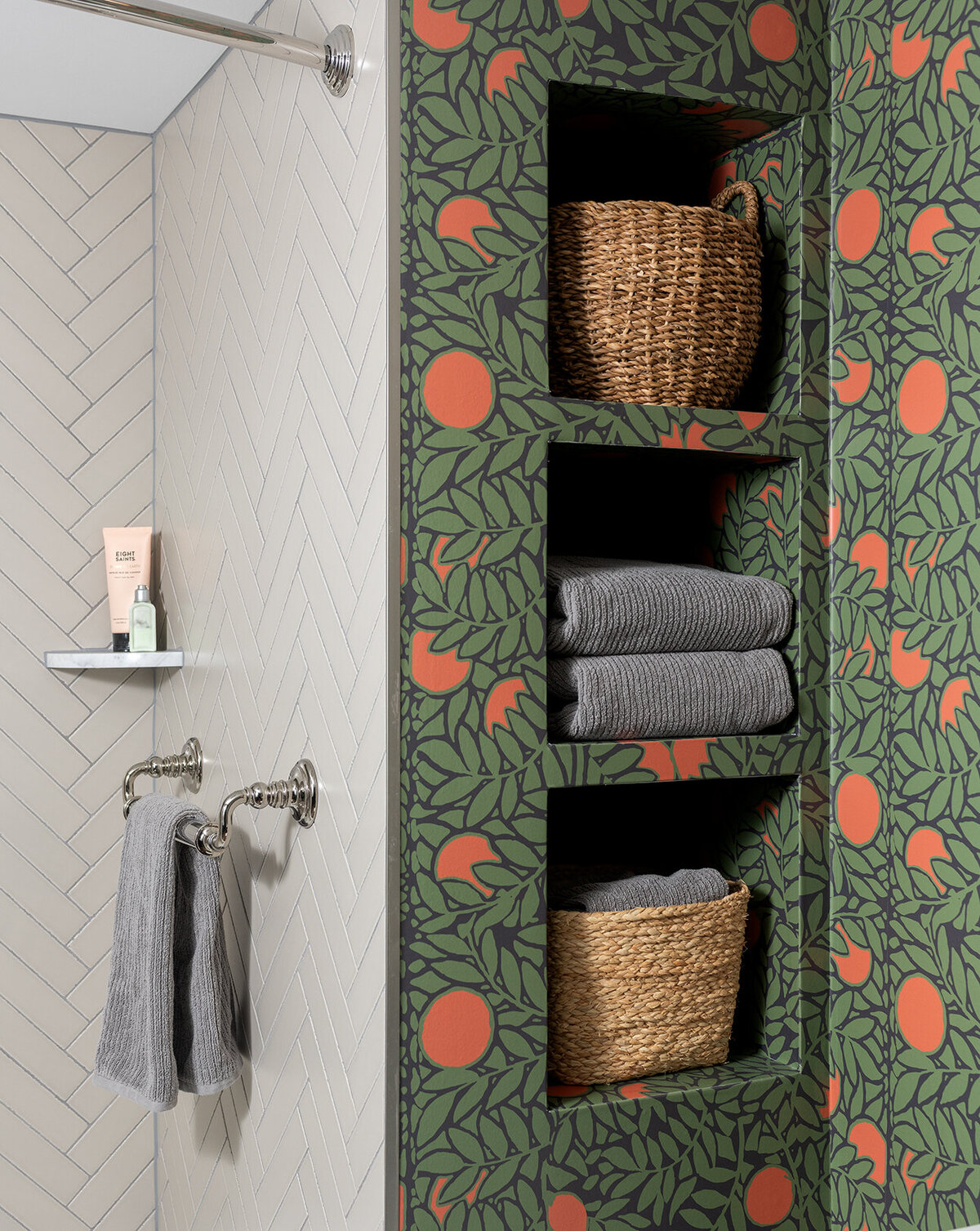 bathroom with orange and green patterned wallpaper and built-in shelves 