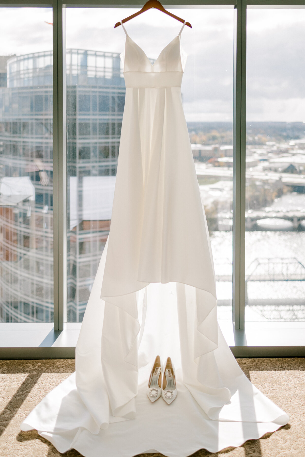 wedding dress hanging in a window
