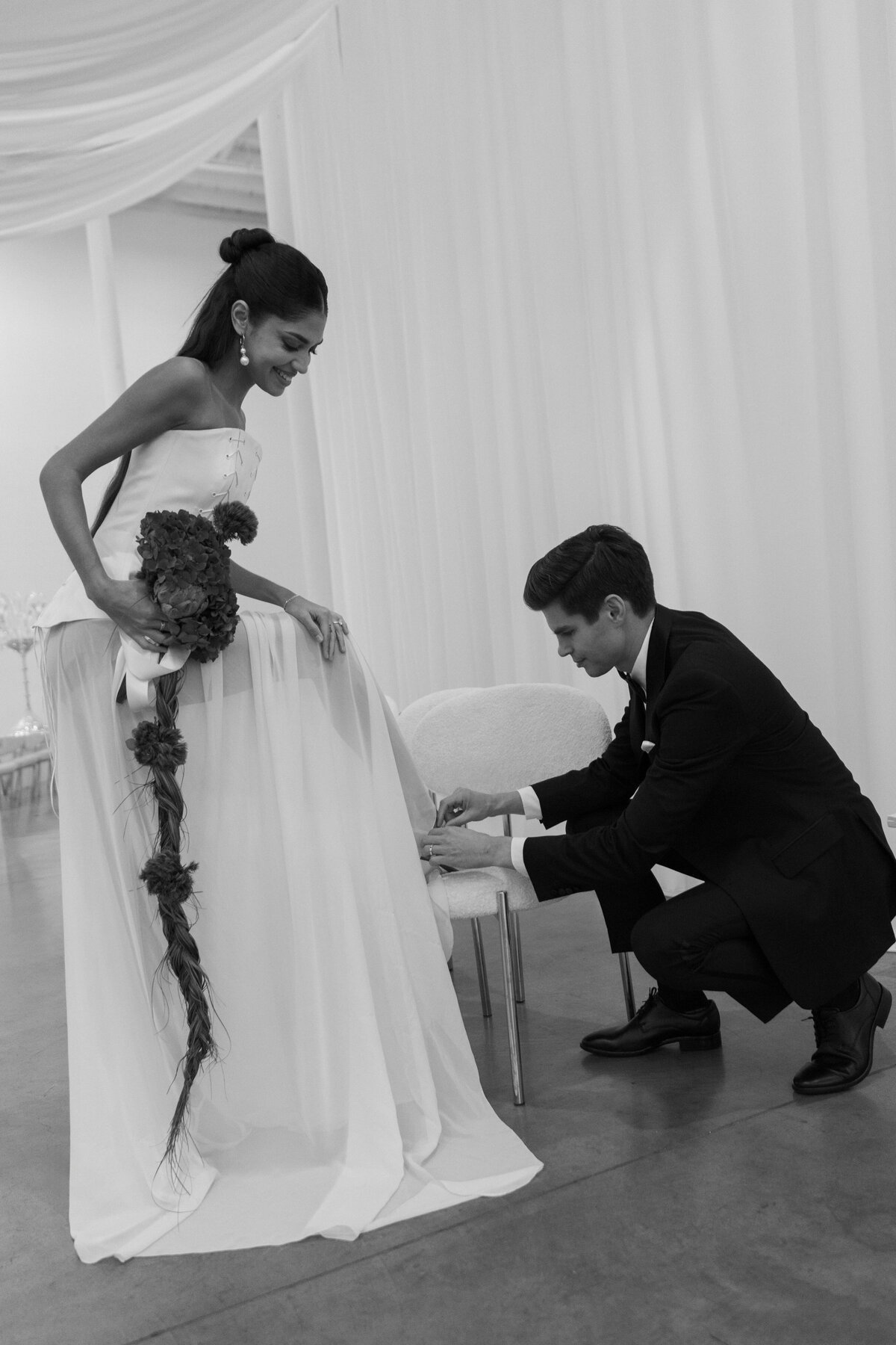 Black-and-white candid portrait of a couple during an editorial wedding session.