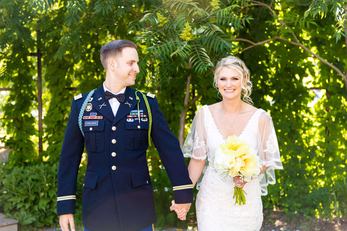 Bride and groom holding hands at Fat Bottom Brewery wedding in Nashville, TN