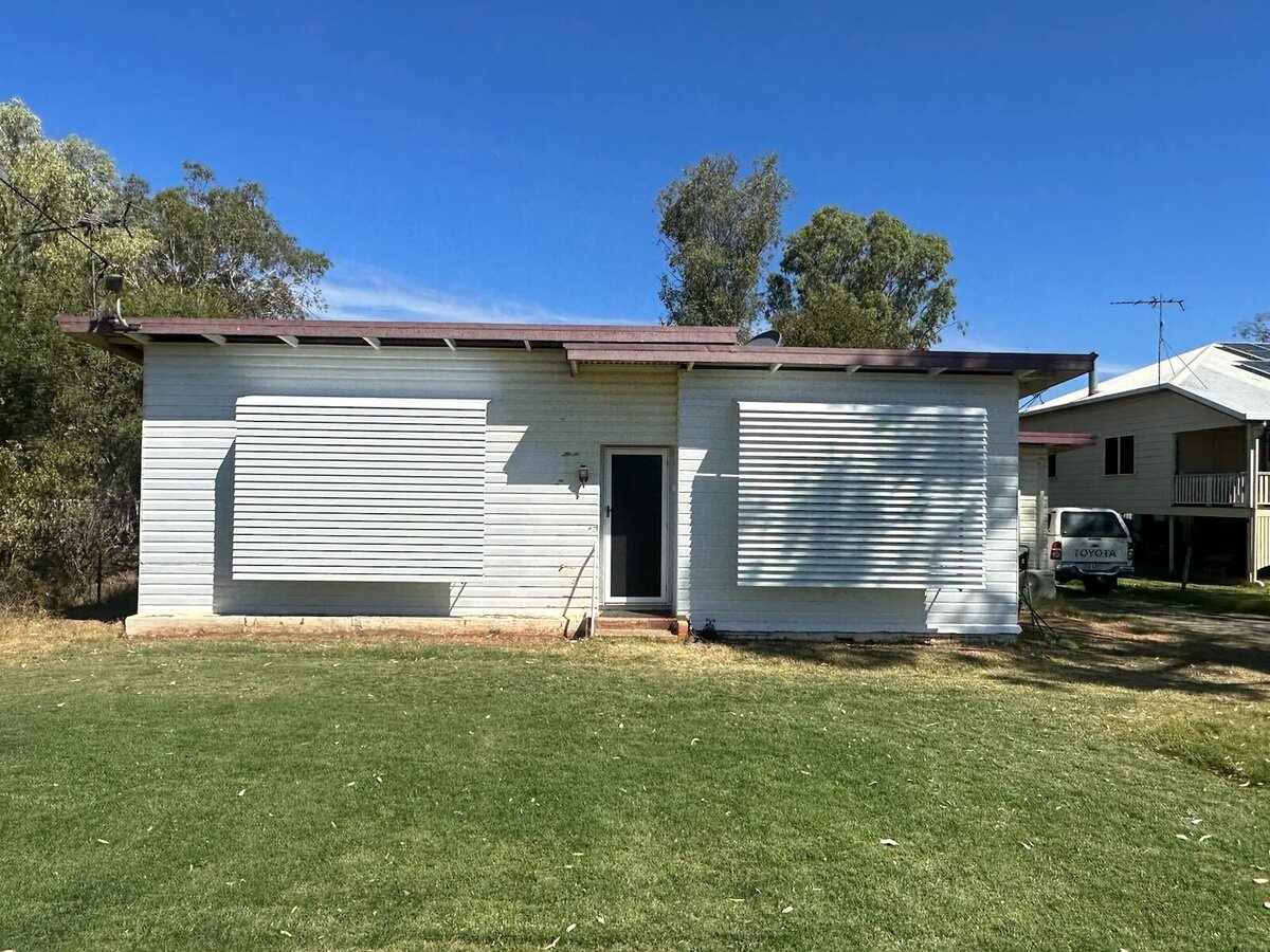 Residential home showcasing durable awning shutters for sun and rain protection.