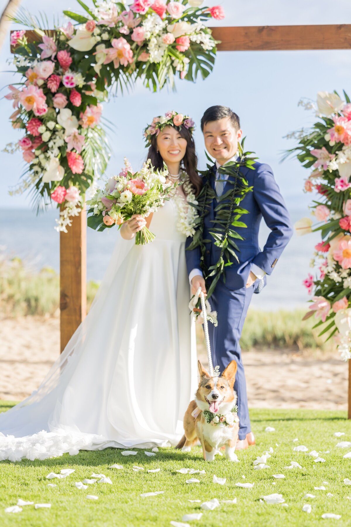 Maui Wedding Photo of bride and groom under elegant arch of flowers