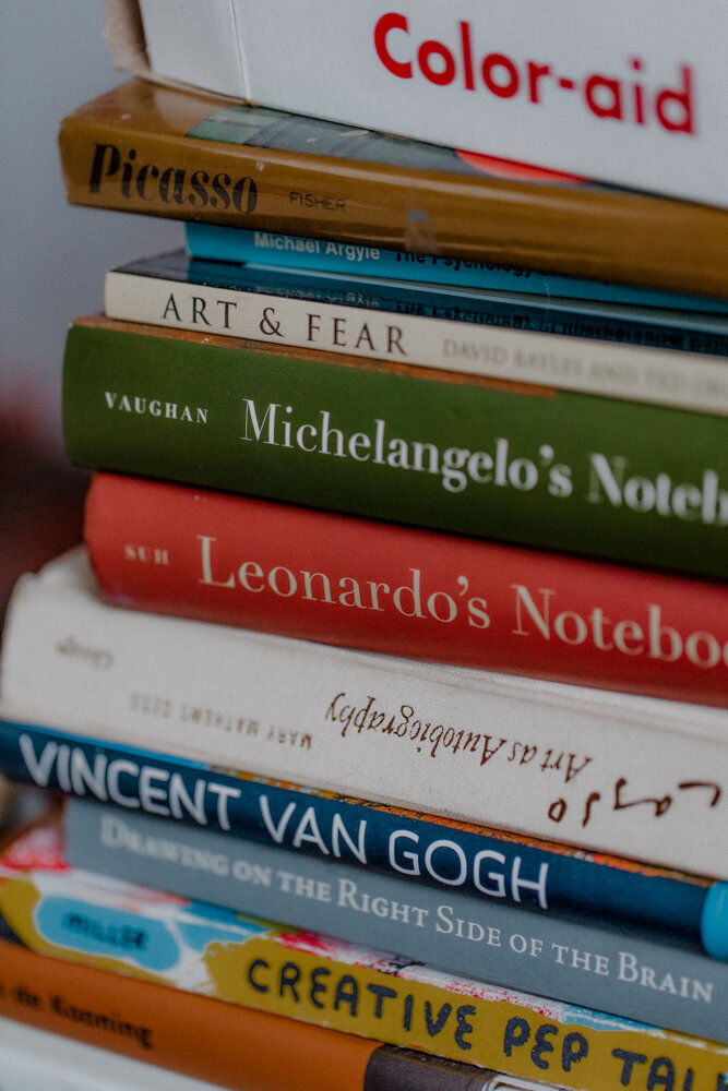a stack of art books