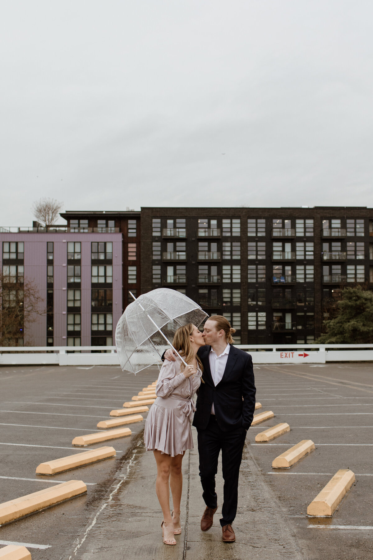 Rainy outdoor engagement session with umbrellas captured by Fort Worth Wedding Photographer, Megan Christine Studio
