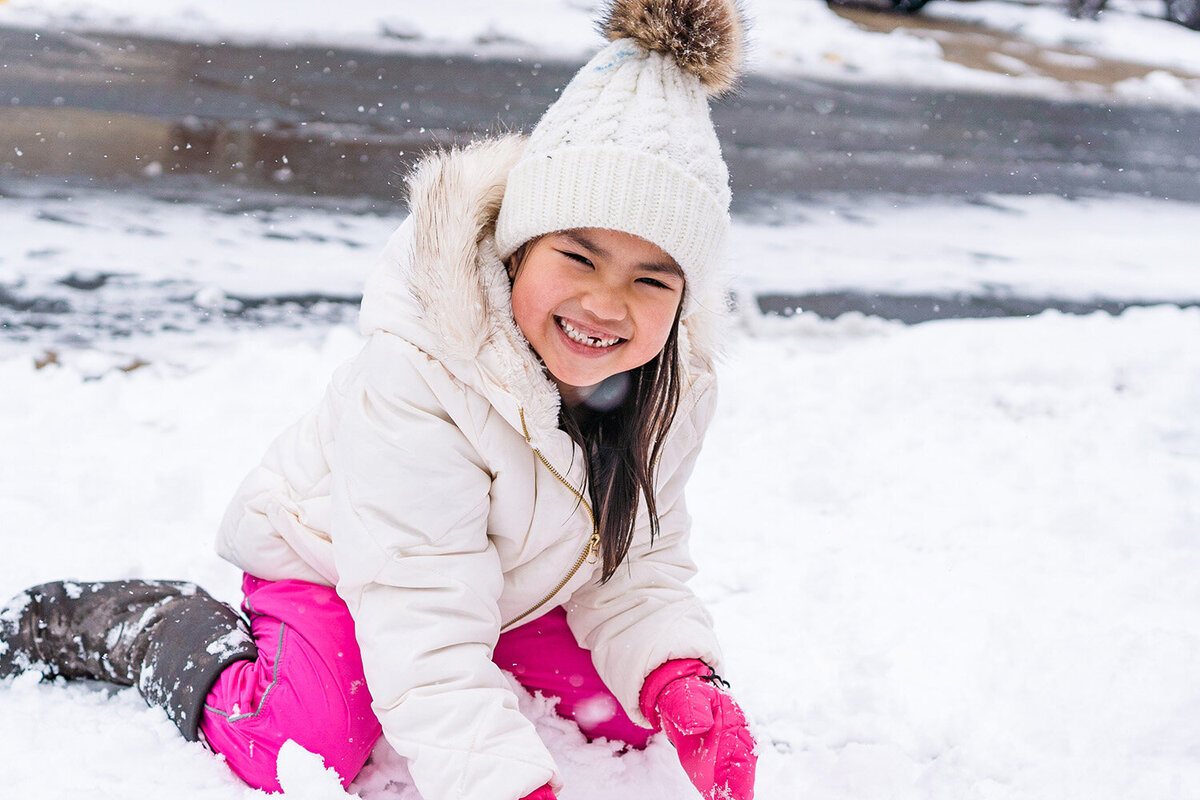 daughter of NoVa family photographer playing in snow
