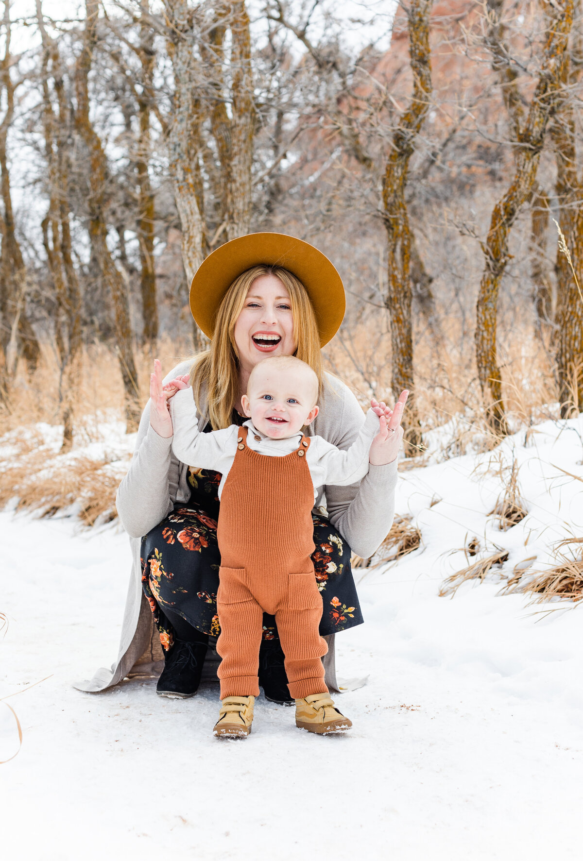 mom and baby smiling together for photos in the snow