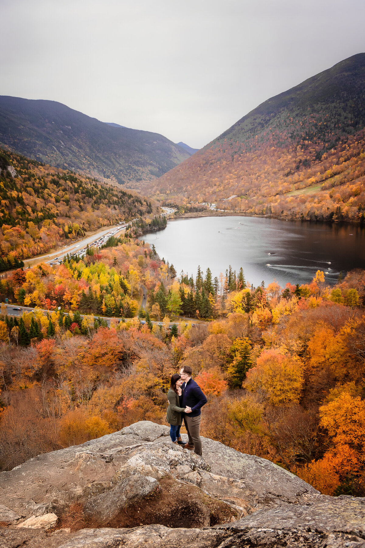 Couple embracing on rocks at Artist Bluff in Lincoln NH
