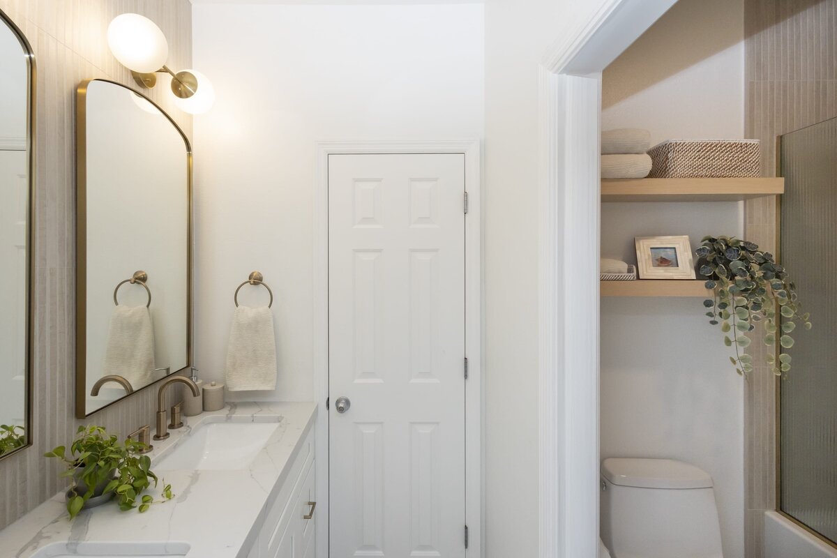 dewine design orlando interior designer contemporary coastal teen bathroom gold mirrors and plant on counter