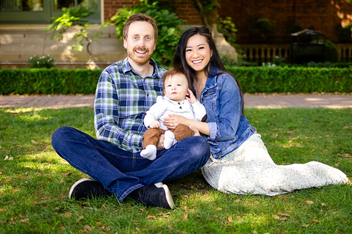 San Francisco Peninsula family photographer Joyful parents holding baby boy close during a candid outdoor family session 