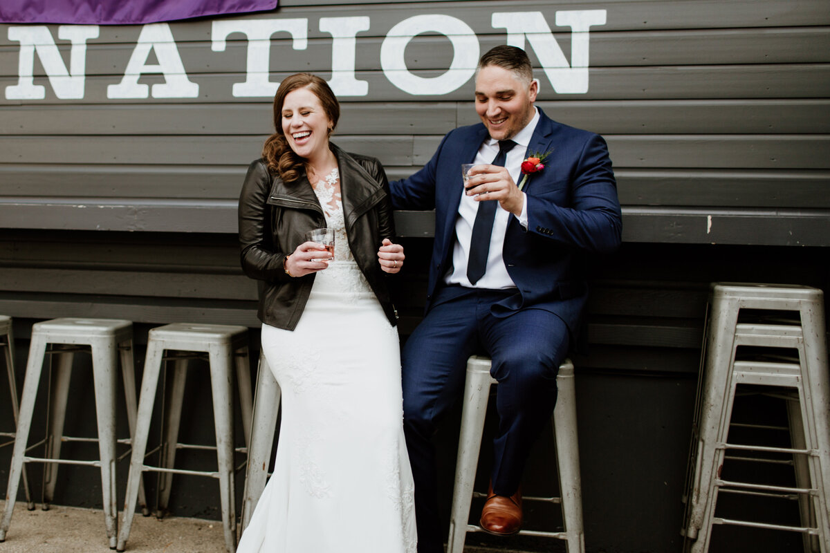 A couple stopped to enjoy a drink during their portrait session captured by Fort Worth wedding photographer, Megan Christine Studio