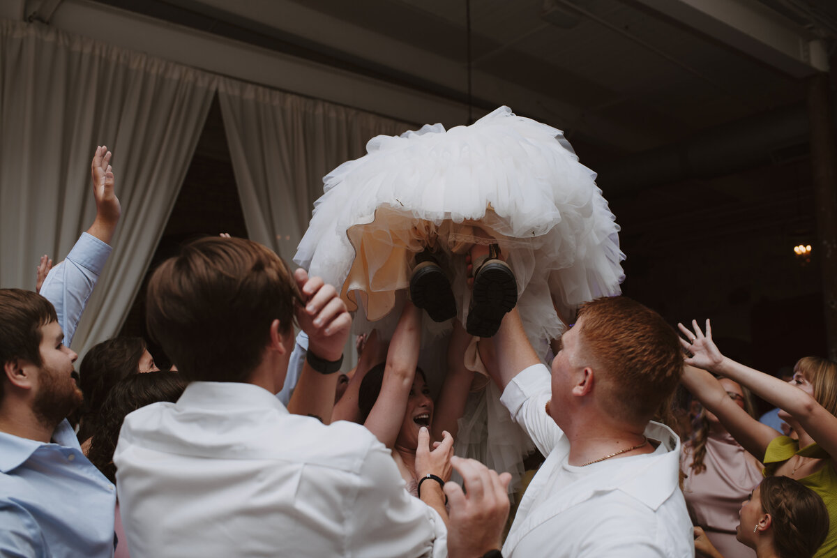 bride getting lifted into air during dancing