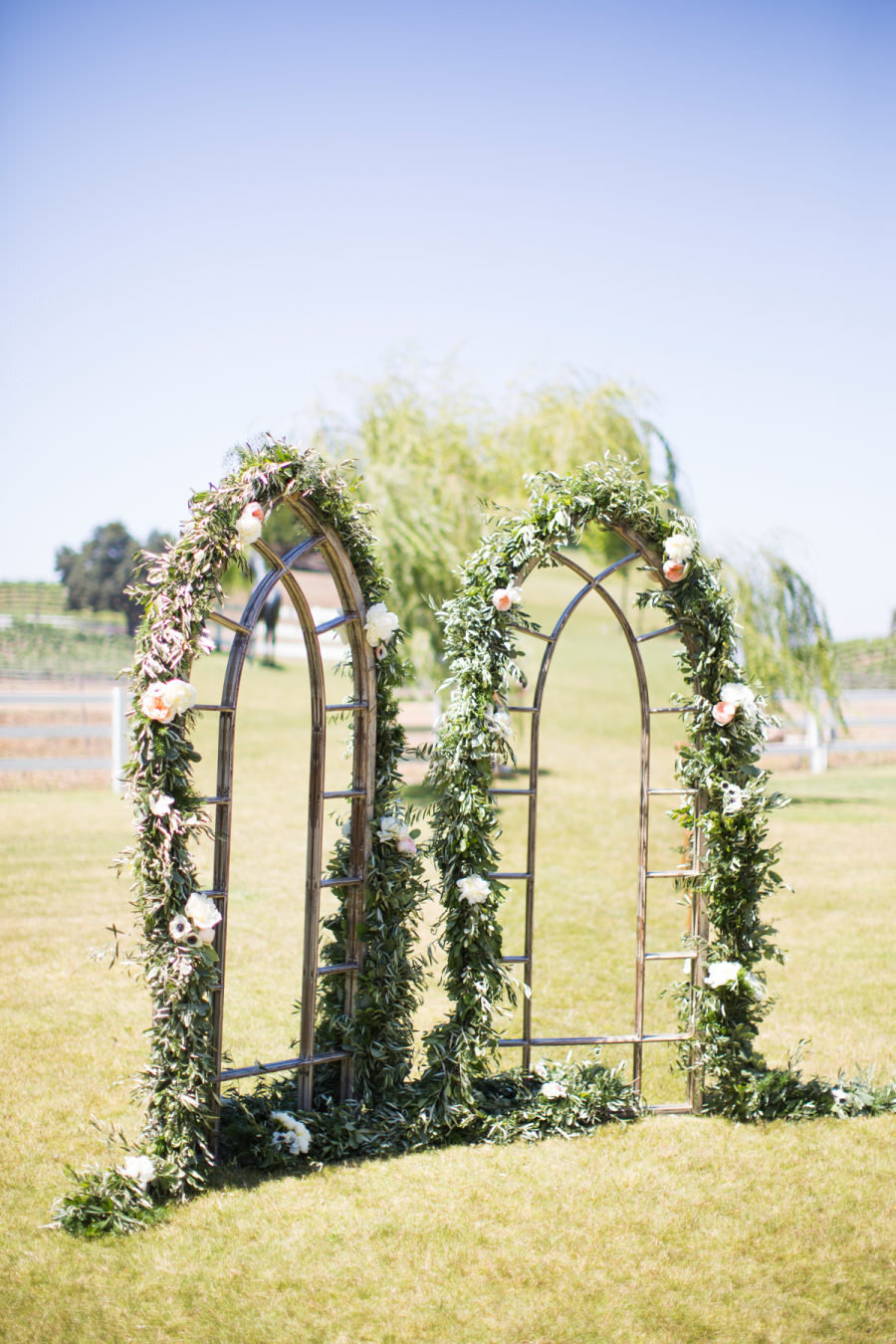 Mirrored arch with garland for ceremony