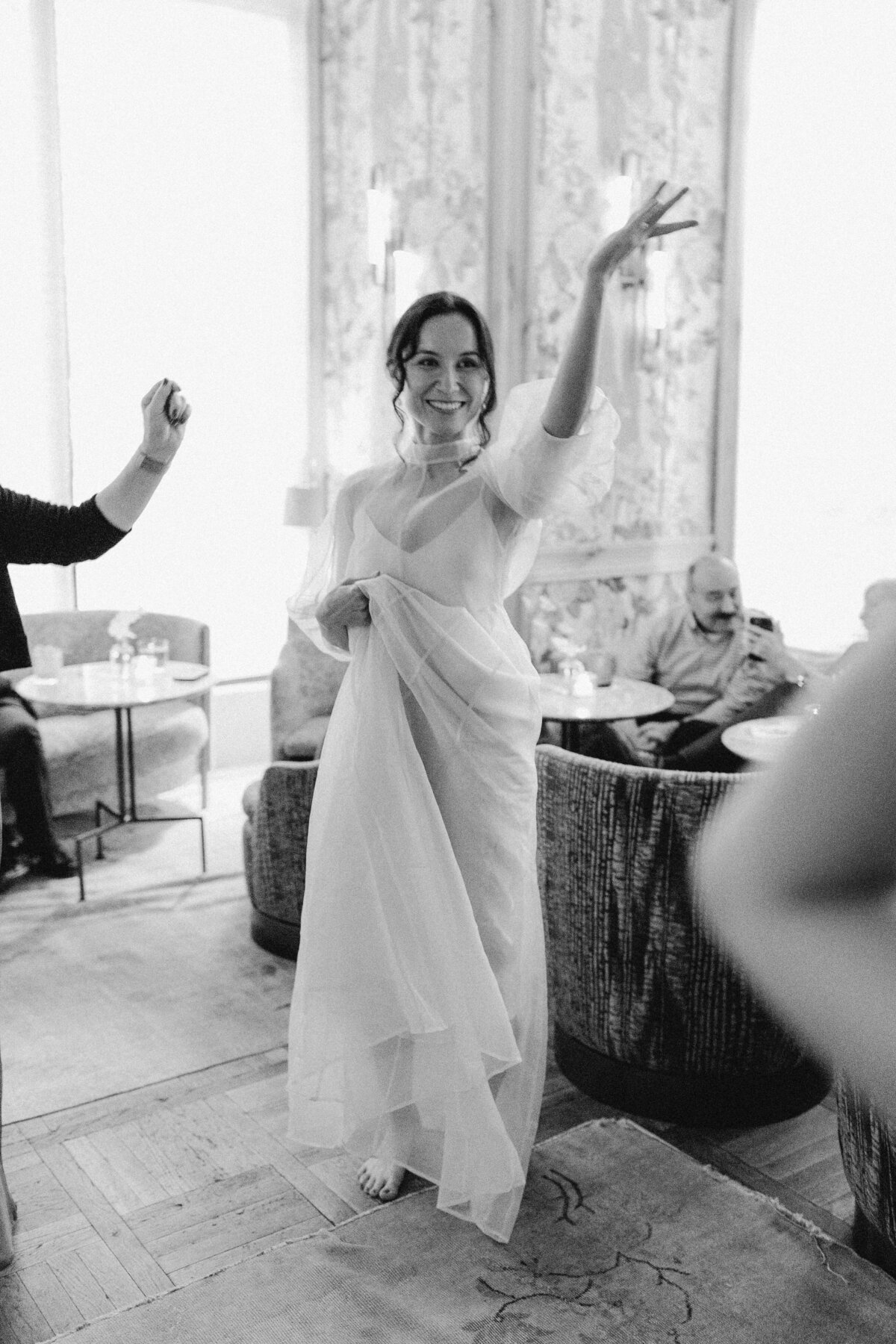 Bride with hand in the air dancing at wedding reception in Austin