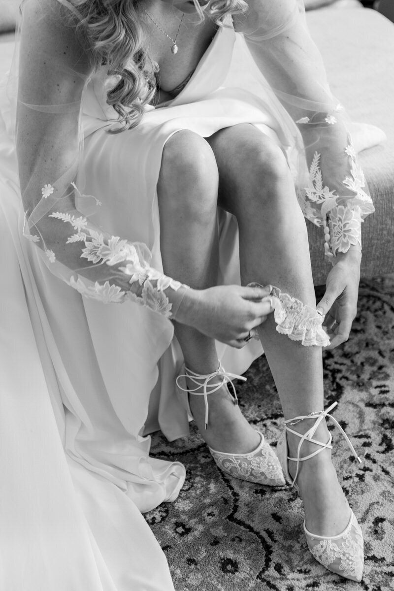 Bride puts on garter Charleston Wedding Photographer