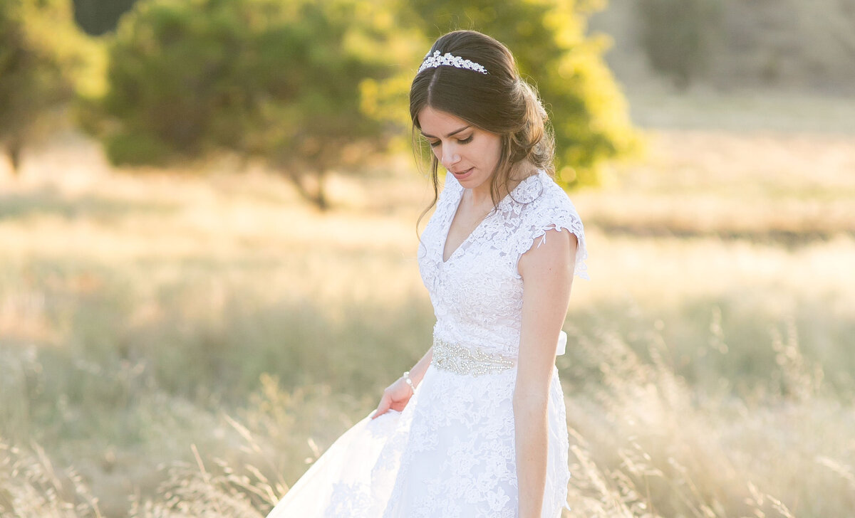 Brunette bride with tiara in a field of grass in San Jose, CA