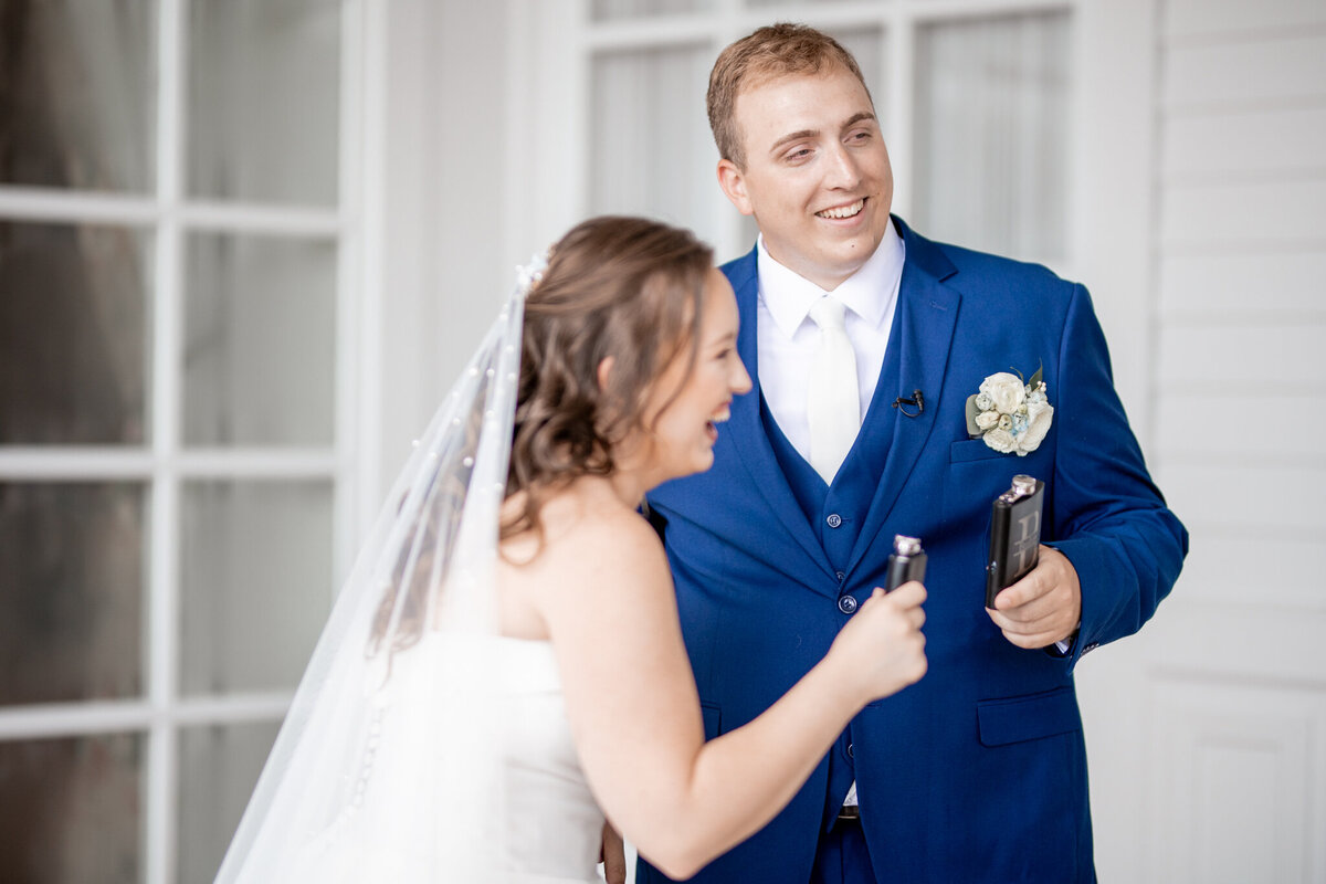 bride and groom sharing a flask