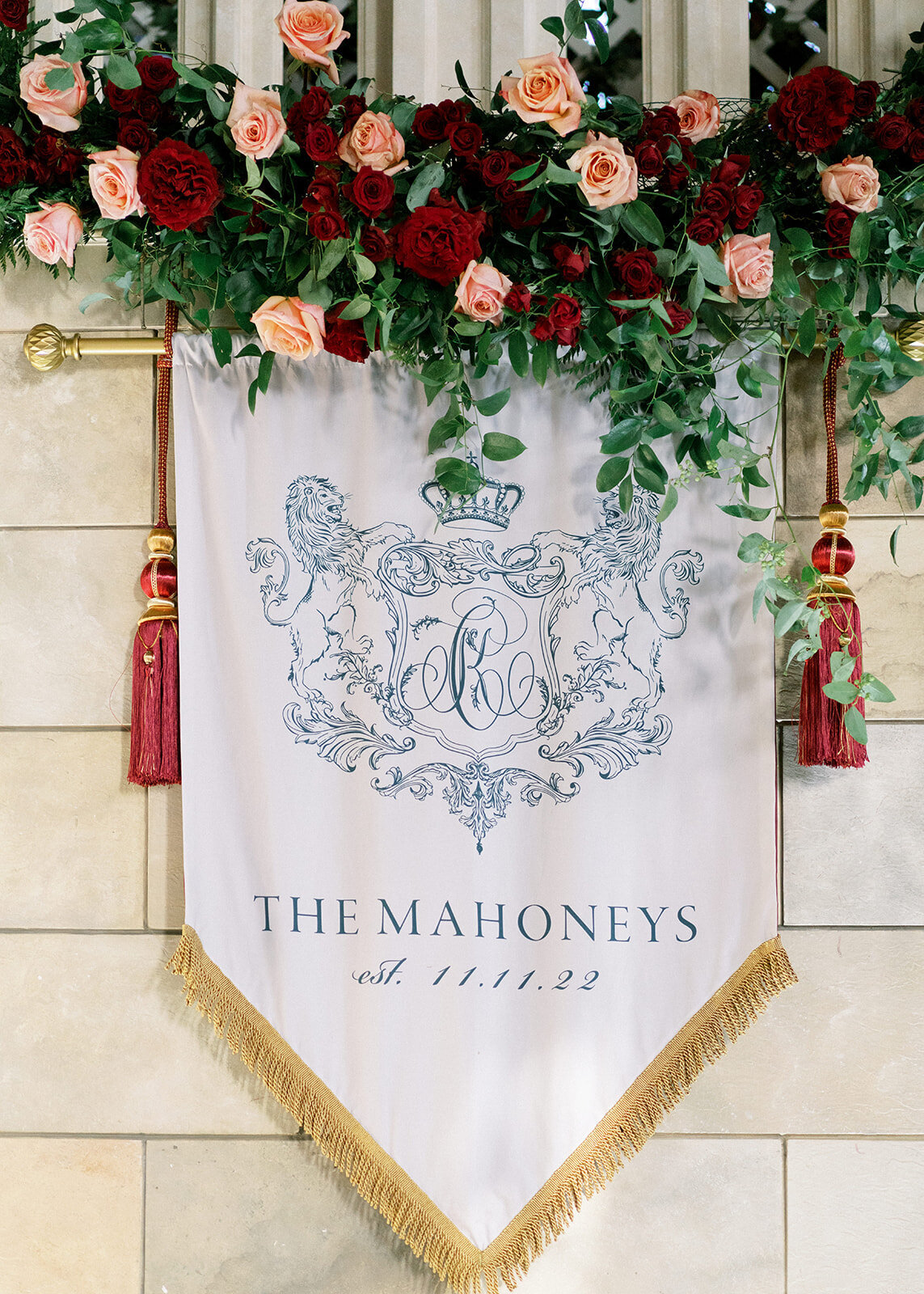 Custom crest banner hanged to the wall with florals