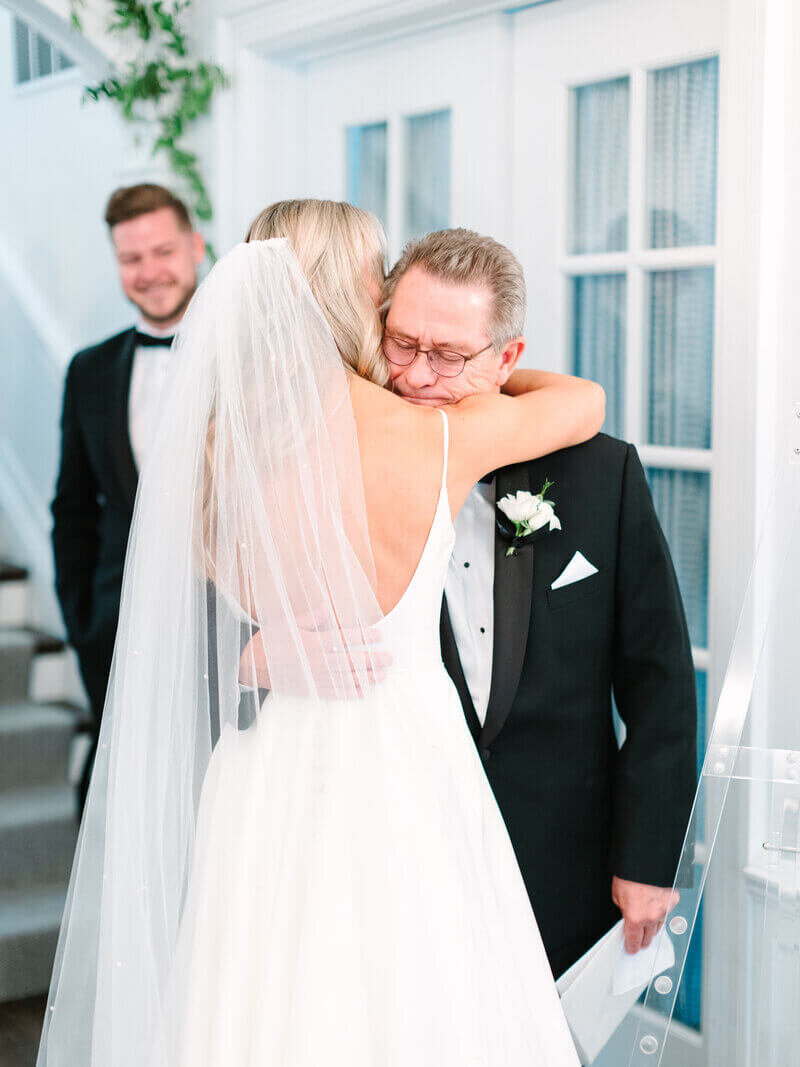 Bride hugging father by chicago wedding planners