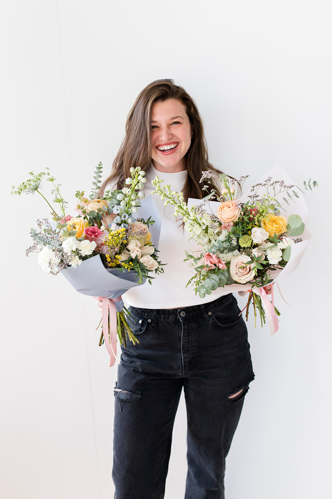 maine florist holding two flower wraps