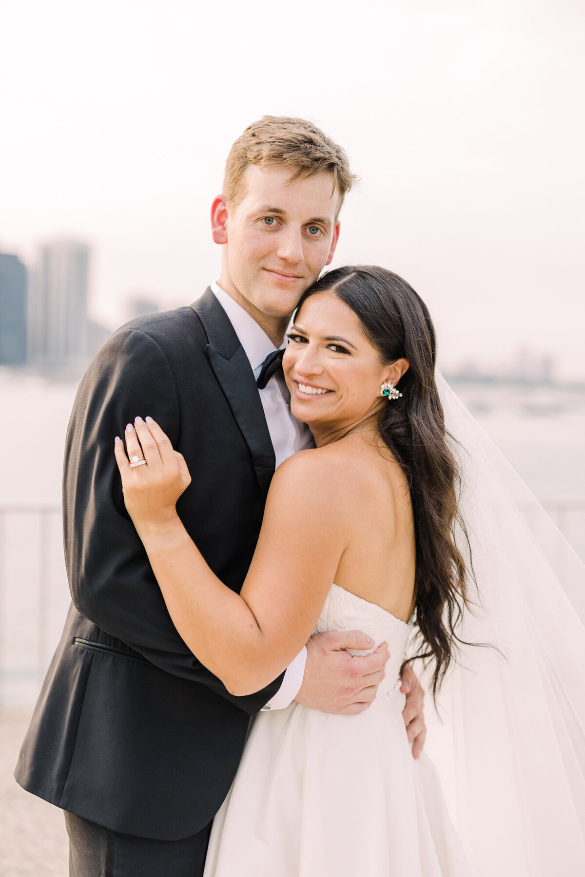 A timeless wedding portrait of a bride and groom standing together in an elegant Chicago venue, captured in soft natural light.