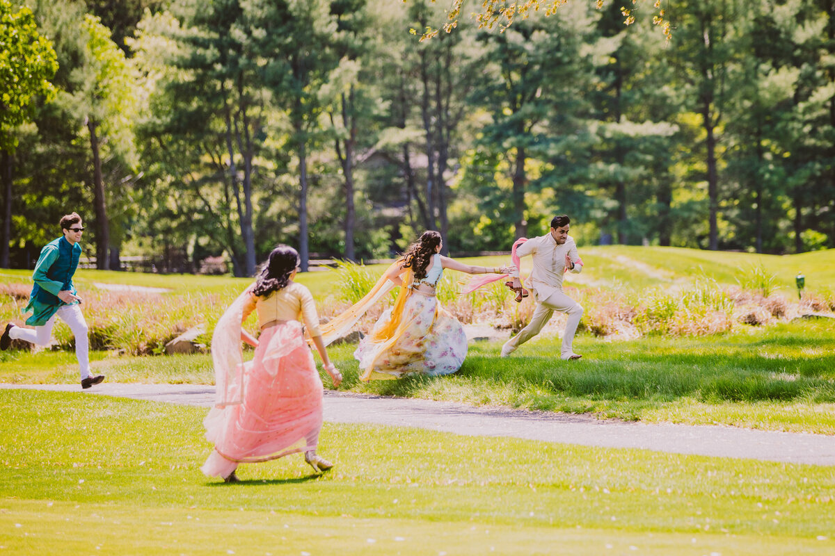 groomsmen running away with the groom's shoes after the hindu wedding ceremony in nj