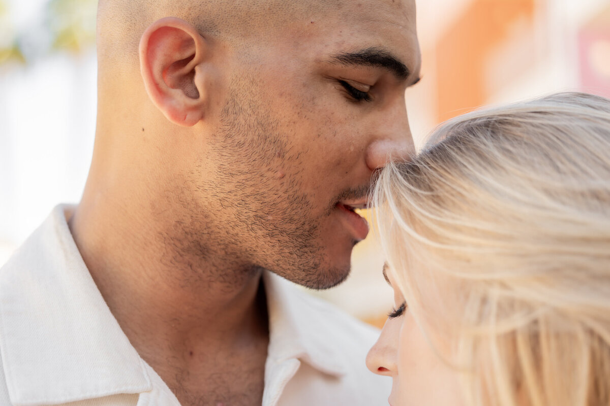 Close-up of couple smiling at one another, sharing a peaceful moment in the desert sun.