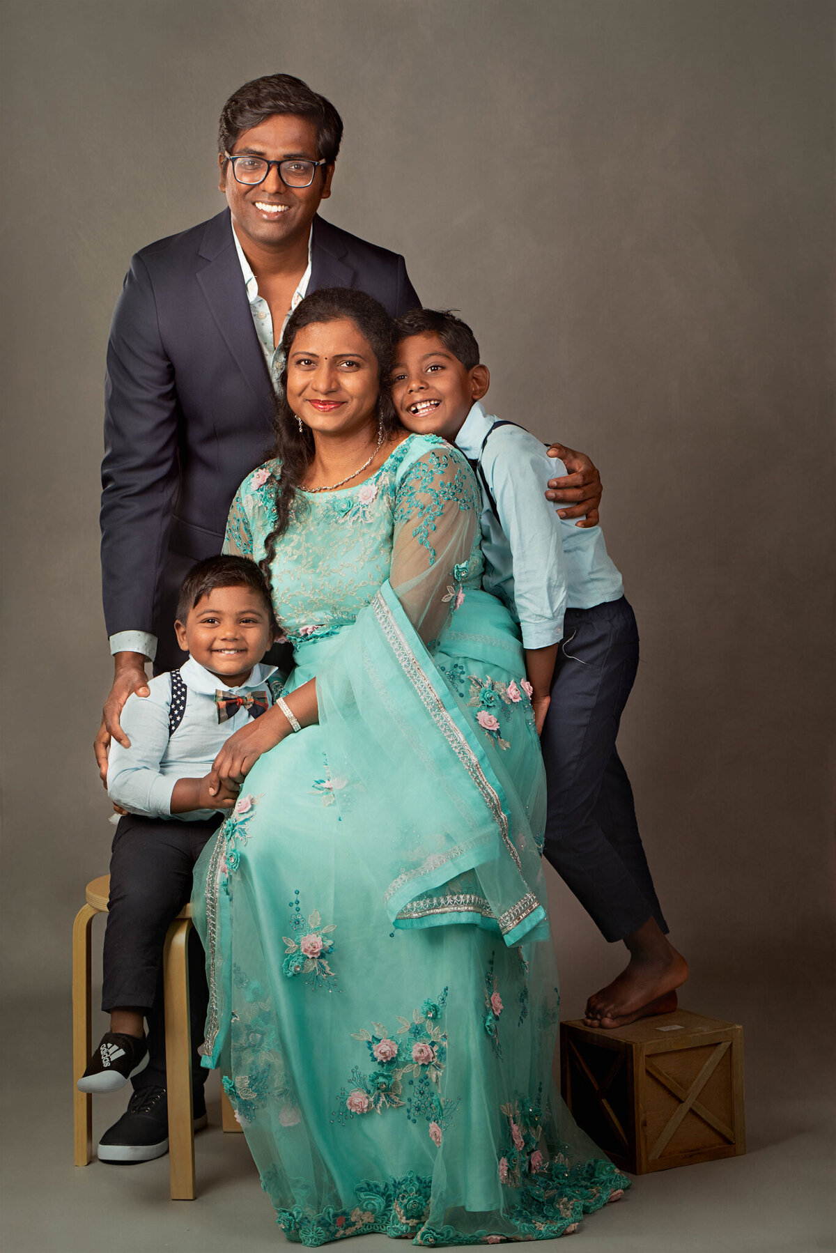 Cheerful family portrait featuring parents and children in bright outfits, captured in Olathe, Kansas. A perfect choice for families seeking vibrant and playful family photography in the Kansas City metro area